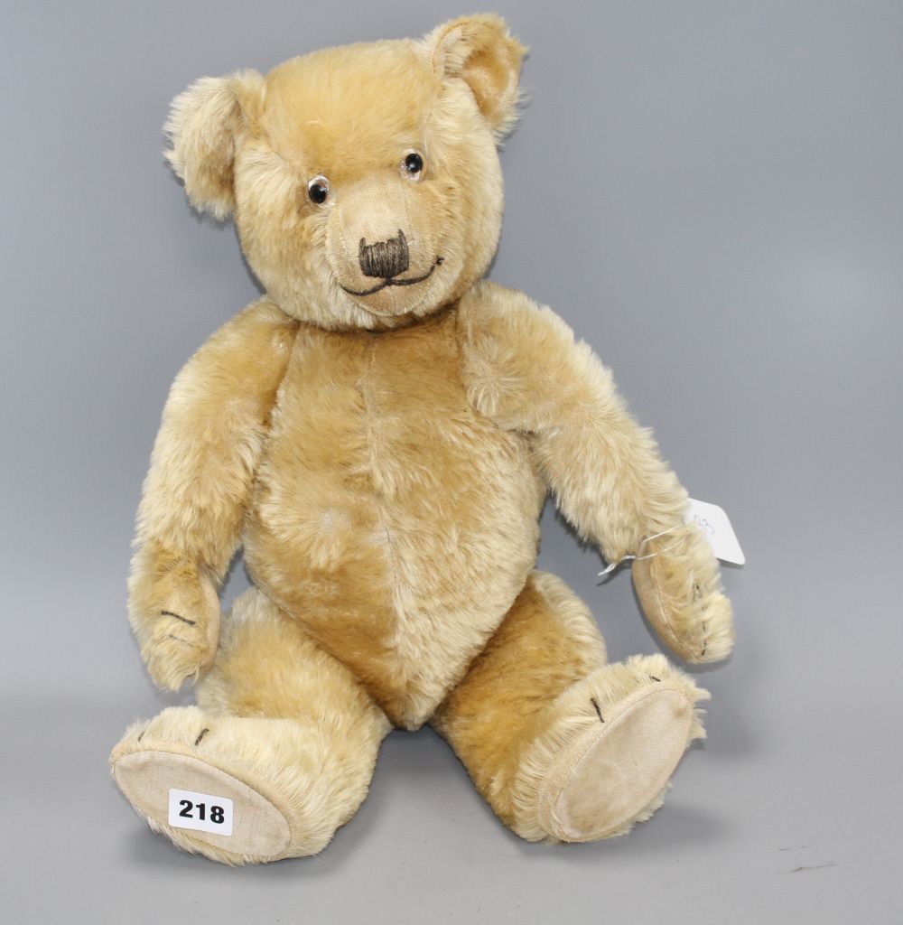 A Chiltern Hugmee bear c.1930s, 19in., blond mohair, good condition, glass eyes and velvet pads